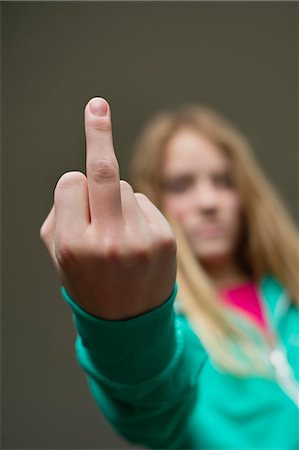 scorn - Girl showing middle finger Stock Photo - Premium Royalty-Free, Code: 6108-06167263