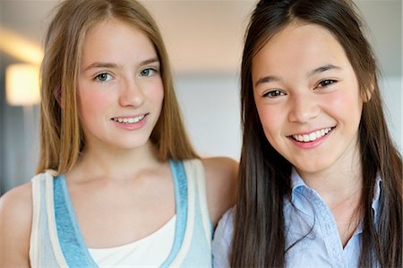 pretty girl in happy - Portrait of two girls smiling Stock Photo - Premium Royalty-Free, Code: 6108-06167295