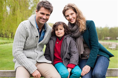 safety family - Boy sitting with his parents on the gate of a cottage Stock Photo - Premium Royalty-Free, Code: 6108-06167318