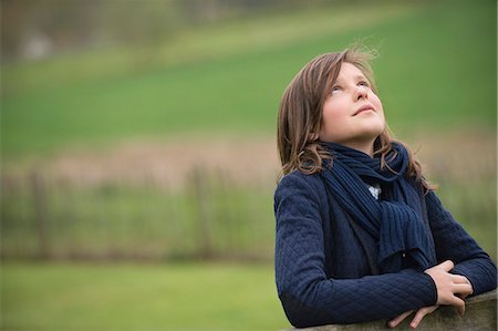 people daydreaming - Girl looking up in a farm Stock Photo - Premium Royalty-Free, Code: 6108-06167319