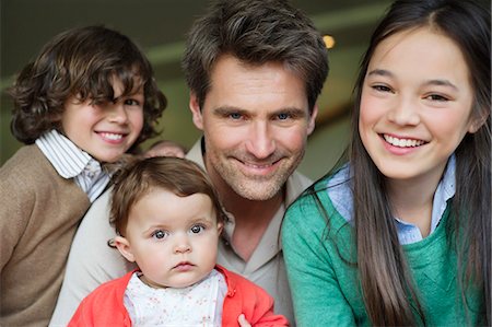 simsearch:6108-06167492,k - Portrait of a happy man with their children smiling Stock Photo - Premium Royalty-Free, Code: 6108-06167460