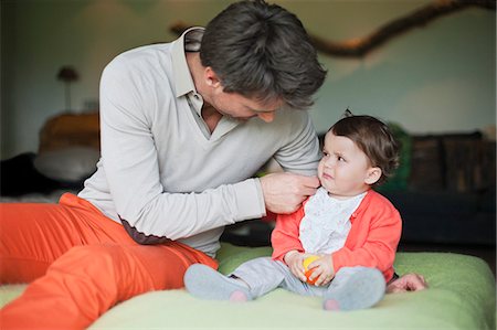 displeased - Man consoling his crying daughter Stock Photo - Premium Royalty-Free, Code: 6108-06167471