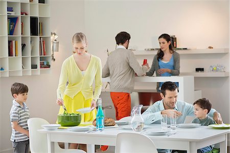 family man dinner table - Family setting table for dinner Stock Photo - Premium Royalty-Free, Code: 6108-06167414