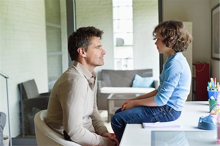 side view in chair - Man with his son looking at each other at home Stock Photo - Premium Royalty-Free, Code: 6108-06167567