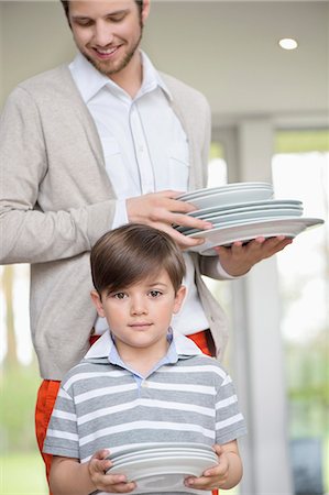 shirts stripes - Man and son arranging plates for lunch Stock Photo - Premium Royalty-Free, Code: 6108-06167579