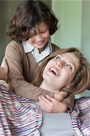 son hugging mom - Close-up of a woman with his son smiling Stock Photo - Premium Royalty-Free, Code: 6108-06167581