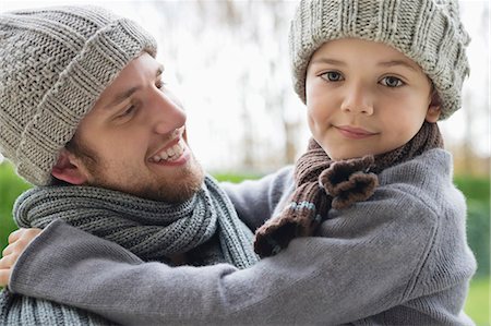 Man carrying his son in a park Stock Photo - Premium Royalty-Free, Code: 6108-06167592