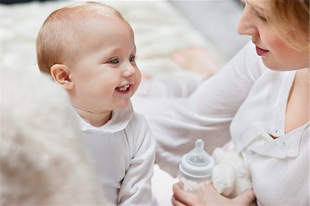 Woman playing with her daughter and smiling Stock Photo - Premium Royalty-Free, Code: 6108-06167765