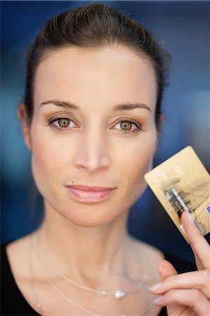 simsearch:6108-06167827,k - Portrait of a businesswoman holding a credit card Stock Photo - Premium Royalty-Free, Code: 6108-06167851