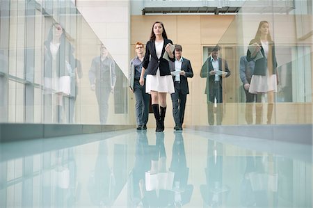 Business executives walking in a corridor Stock Photo - Premium Royalty-Free, Code: 6108-06168063