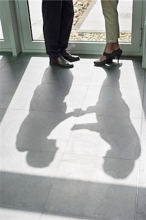 Shadow of two business executives shaking hands Stock Photo - Premium Royalty-Free, Code: 6108-06168004