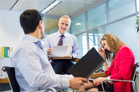 perplex - Business executives discussing in an office Stock Photo - Premium Royalty-Free, Code: 6108-06168197