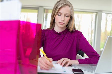 Businesswoman working in the home office Stock Photo - Premium Royalty-Free, Code: 6108-06168105