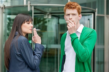 picture woman smoking cigarette - Business executives smoking in front of an office building Stock Photo - Premium Royalty-Free, Code: 6108-06168310