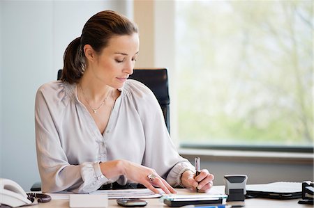 simsearch:6108-06167827,k - Businesswoman working in an office Stock Photo - Premium Royalty-Free, Code: 6108-06168321