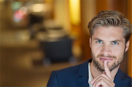 silence - Portrait of a man with his finger on lips Stock Photo - Premium Royalty-Free, Code: 6108-06904954