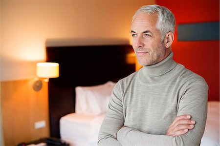 simsearch:6108-06907153,k - Man with arms crossed in a hotel room Stock Photo - Premium Royalty-Free, Code: 6108-06904976