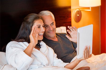 simsearch:6108-06904945,k - Couple video calling on a digital tablet in a hotel room Stock Photo - Premium Royalty-Free, Code: 6108-06905003