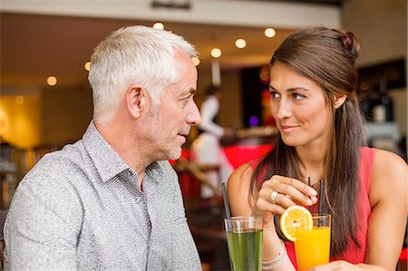 Couple enjoying drinks in a restaurant Stock Photo - Premium Royalty-Free, Code: 6108-06905035