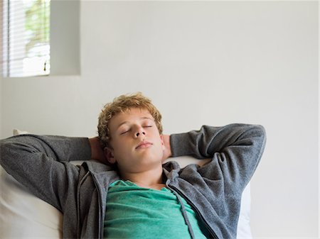 Teenage boy sleeping on the bed Stock Photo - Premium Royalty-Free, Code: 6108-06905244