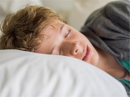 Teenage boy sleeping on the bed Photographie de stock - Premium Libres de Droits, Code: 6108-06905246