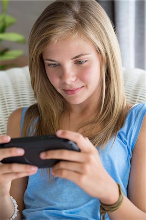 simsearch:6108-06905230,k - Close-up of a girl playing video game Stock Photo - Premium Royalty-Free, Code: 6108-06905268
