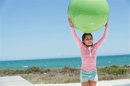 simsearch:6108-06907957,k - Girl holding a fitness ball on the beach Stock Photo - Premium Royalty-Free, Code: 6108-06905322
