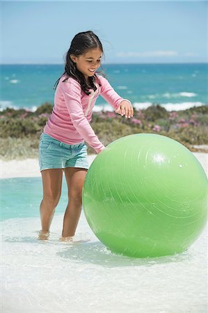 simsearch:6108-06907957,k - Girl playing with a fitness ball on the beach Stock Photo - Premium Royalty-Free, Code: 6108-06905328