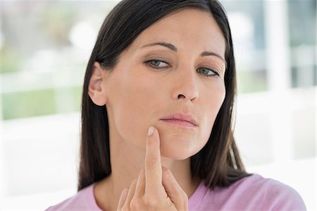 Woman checking wrinkles on her face Stockbilder - Premium RF Lizenzfrei, Bildnummer: 6108-06905656