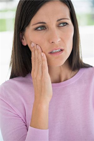 Woman suffering from a toothache Stock Photo - Premium Royalty-Free, Code: 6108-06905660