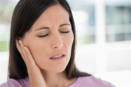 simsearch:6108-06167824,k - Woman suffering from an ear ache Stock Photo - Premium Royalty-Free, Code: 6108-06905678