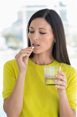 simsearch:6108-05867295,k - Woman taking medicine Stock Photo - Premium Royalty-Free, Code: 6108-06905693