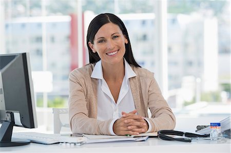 female smiling desk - Portrait of a smiling receptionist in a doctor's office Stock Photo - Premium Royalty-Free, Code: 6108-06905697