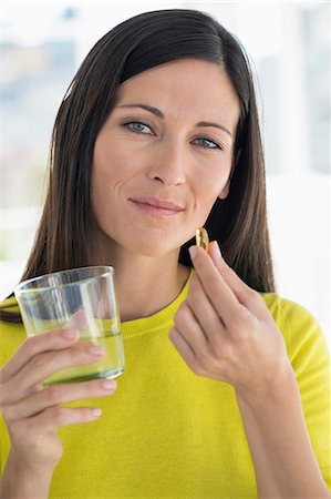 simsearch:6108-05867295,k - Portrait of a woman taking medicine Stock Photo - Premium Royalty-Free, Code: 6108-06905638