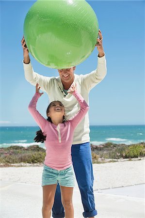 families playing on the beach - Man playing with his granddaughter on the beach Stock Photo - Premium Royalty-Free, Code: 6108-06905933