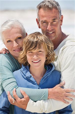 Portrait of a boy with his grandparents on the beach Stock Photo - Premium Royalty-Free, Code: 6108-06905935