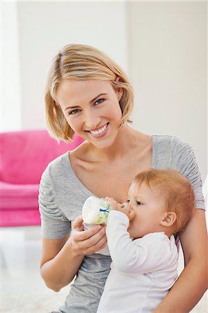 parents and baby - Woman feeding milk her baby with a bottle Stock Photo - Premium Royalty-Free, Code: 6108-06906041