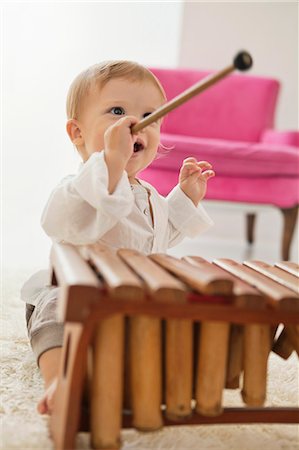 Baby boy playing a xylophone Stock Photo - Premium Royalty-Free, Code: 6108-06906055