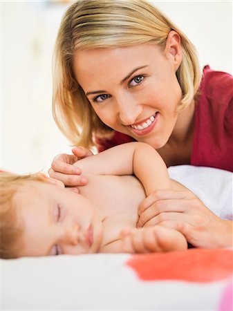 simsearch:6108-06907900,k - Woman near her baby sleeping on the bed Stock Photo - Premium Royalty-Free, Code: 6108-06906073