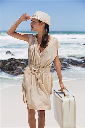 simsearch:6108-06907213,k - Beautiful woman carrying a suitcase on the beach Stock Photo - Premium Royalty-Free, Code: 6108-06906318