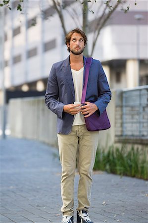 standing - Man standing on a street looking up Stock Photo - Premium Royalty-Free, Code: 6108-06906527