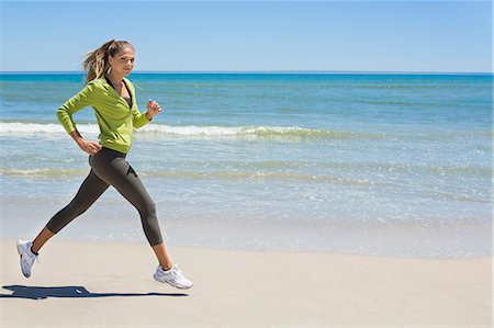 running on sand images - Woman jogging on the beach Stock Photo - Premium Royalty-Free, Code: 6108-06906602