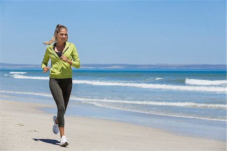 running on sand images - Woman jogging on the beach Stock Photo - Premium Royalty-Free, Code: 6108-06906609