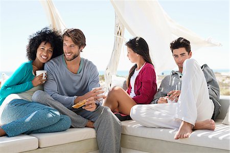 friend - Smiling friends enjoying coffee on the terrace Stock Photo - Premium Royalty-Free, Code: 6108-06906775