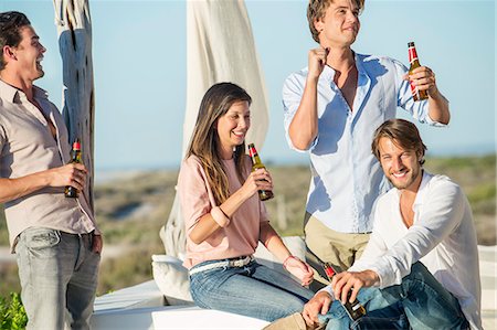 friends outside 30s - Group of friends enjoying beer outdoors on vacation Stock Photo - Premium Royalty-Free, Code: 6108-06906838