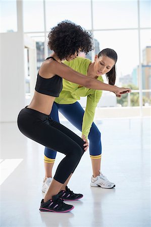 simsearch:6108-06906954,k - Female instructor assisting a woman in a gym Stock Photo - Premium Royalty-Free, Code: 6108-06906988