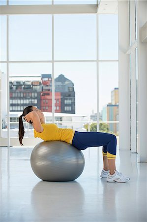 simsearch:6108-06906954,k - Woman exercising on a fitness ball in a gym Stock Photo - Premium Royalty-Free, Code: 6108-06906989