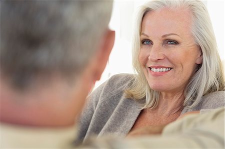 seniors back interior - Close-up of a senior woman smiling with her husband Stock Photo - Premium Royalty-Free, Code: 6108-06906910