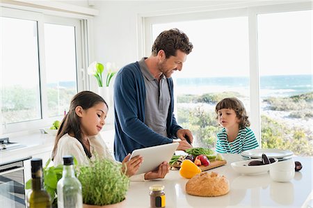 family and food - Man preparing food for his children Stock Photo - Premium Royalty-Free, Code: 6108-06907093