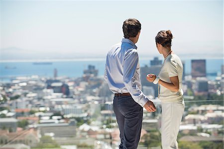 simsearch:6108-06907503,k - Couple looking at city view from a terrace Stock Photo - Premium Royalty-Free, Code: 6108-06907170